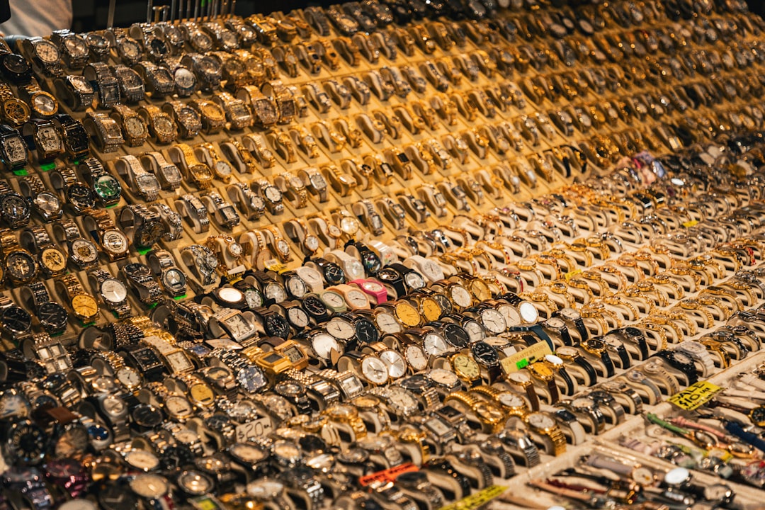 Watches are displayed on a table for sale.